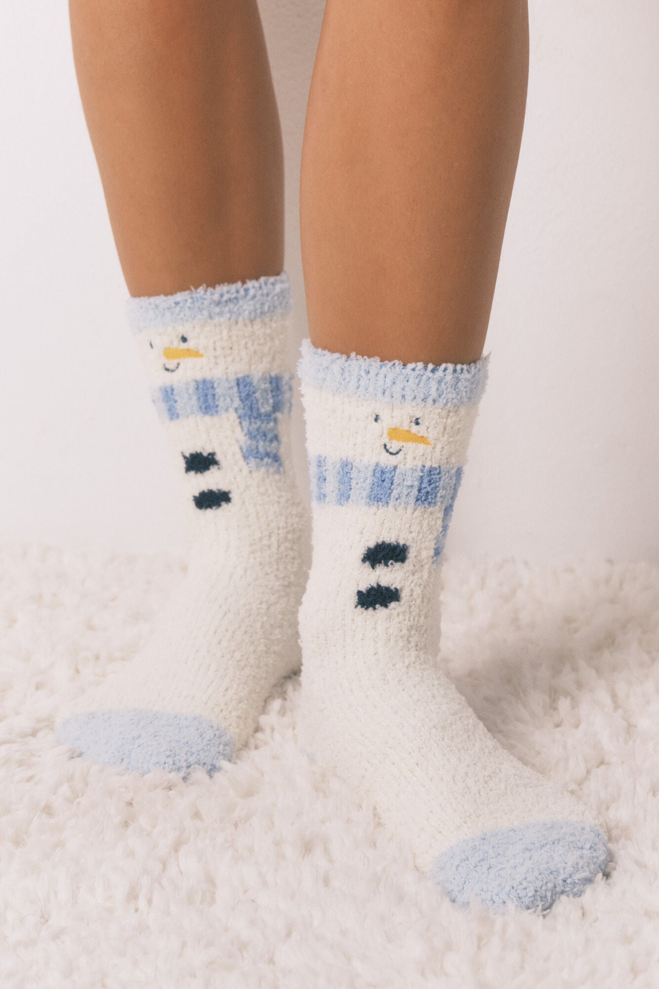 Long fur socks with snowman print.