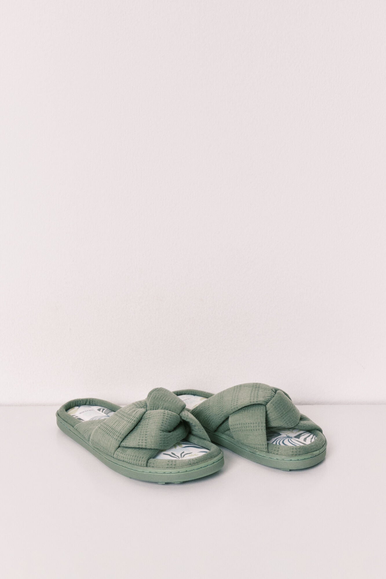 green knotted house slippers