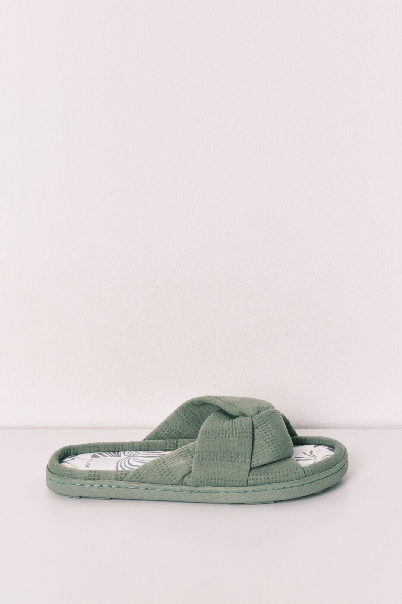 green knotted house slippers