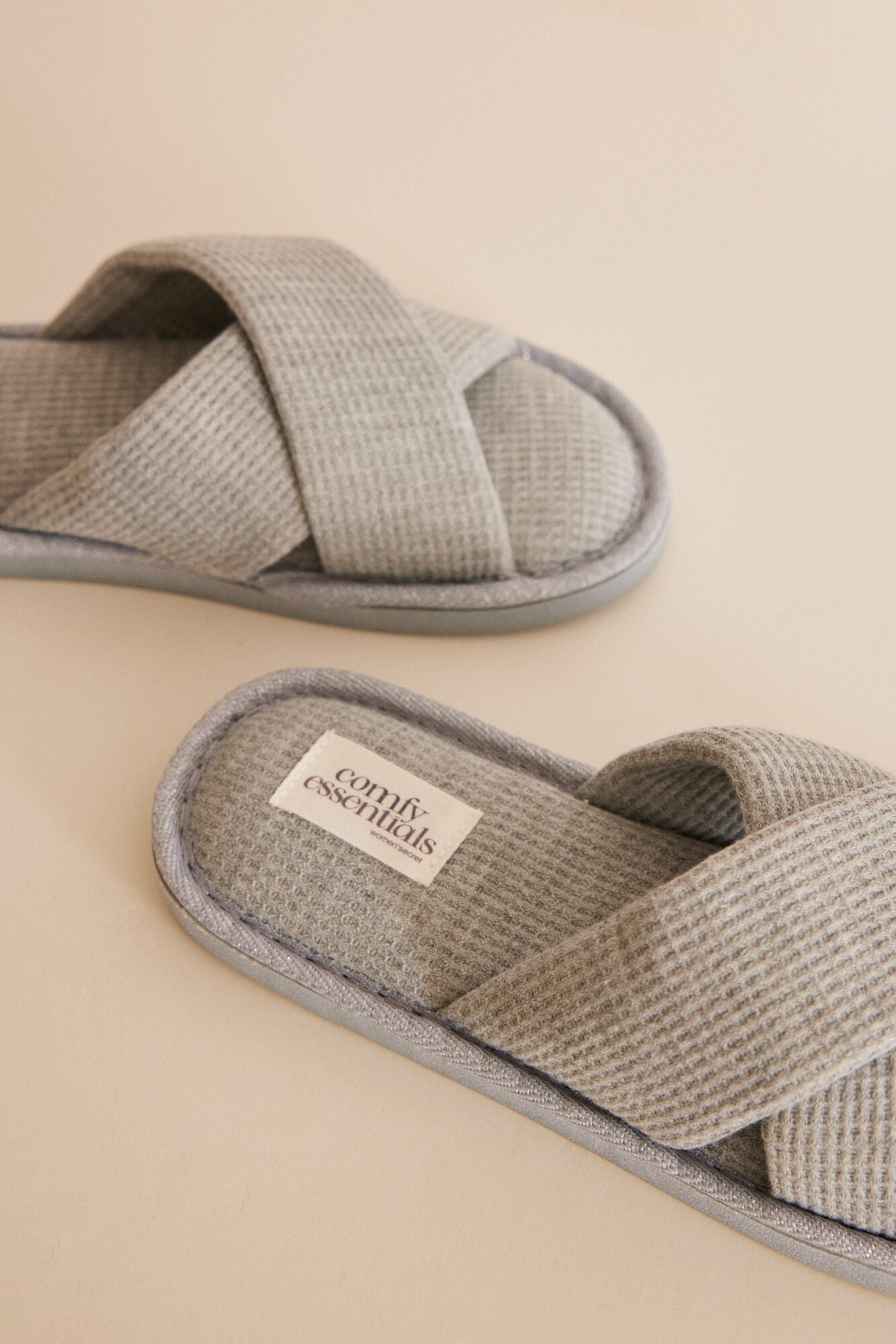Grey slippers with crossover straps