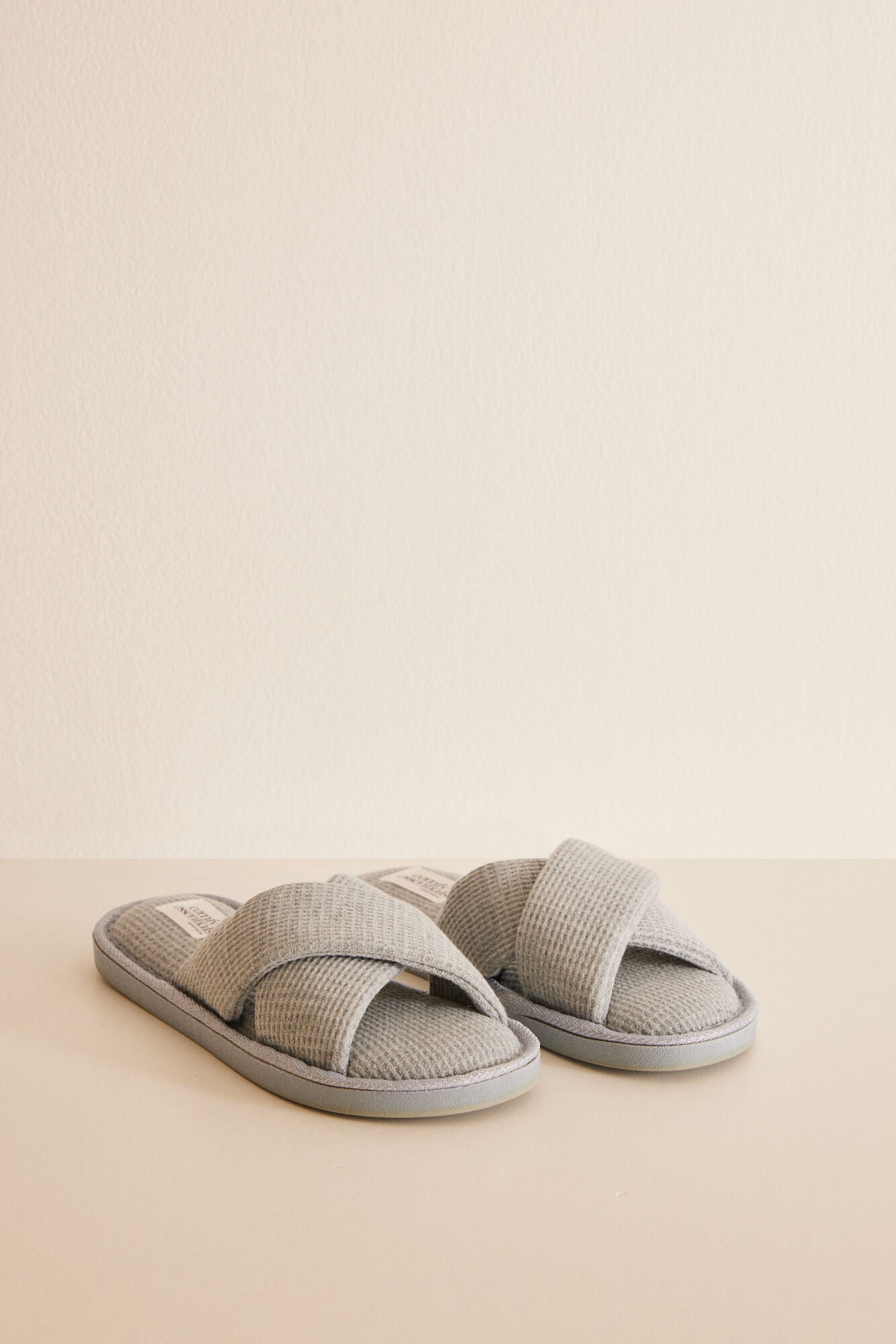 Grey slippers with crossover straps